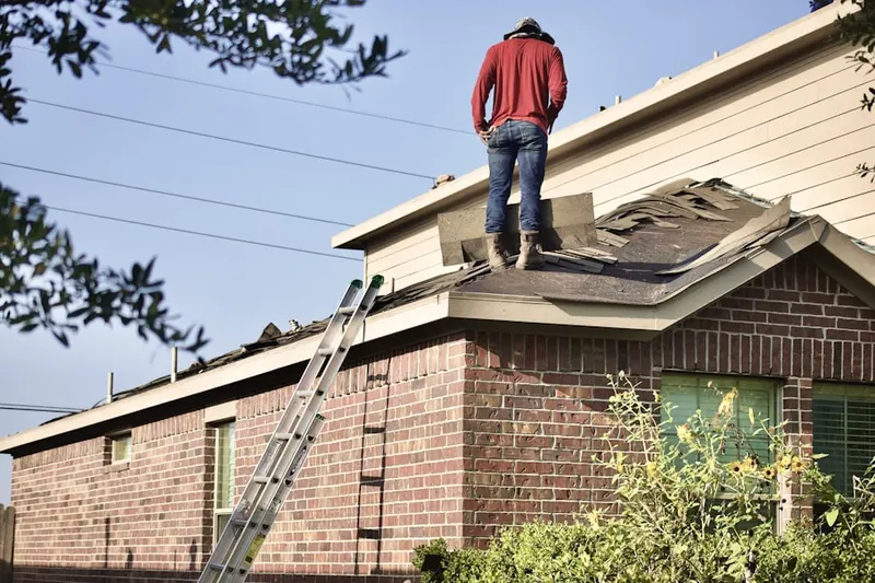 Professional roofer working on a residential roof in Villages of Lake Forest